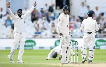  ?? / GARETH COPLEY/GETTY IMAGES ?? James Anderson of England, centre, reacts after being caught out by Ajinkya Rahane, left, of India at Trent Bridge yesterday.