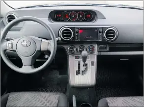 ??  ?? The dashboard of the 2015 Scion xB is a large swath of grey plastic.