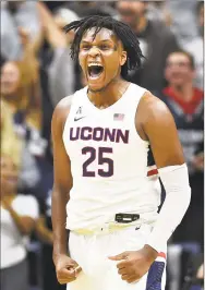  ?? Stephen Dunn / Associated Press ?? UConn’s Josh Carlton screams after blocking a shot in the second half against Sacred Heart.