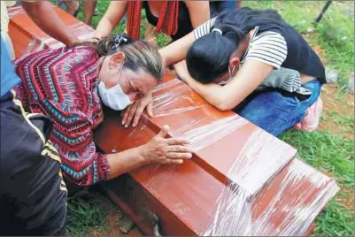  ?? JAIME SALDARRIAG­A / REUTERS ?? Women cry next to a coffin in a cemetery after flooding and mudslides caused by heavy rain led several rivers to overflow, pushing sediment and rocks into buildings and roads in Mocoa, Colombia.