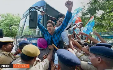  ?? — PTI ?? The police detains NSUI activists during a protest outside the residence of Union home minister Rajnath Singh in New Delhi on Tuesday over the issue of black money.