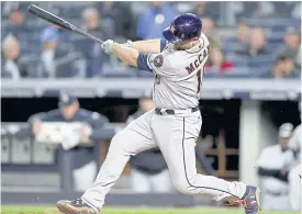  ??  ?? The Astros’ Brian McCann hits a three-run home run in the fourth inning.