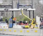  ?? Paul Buckowski / Times Union ?? Workers start taking tollbooths away last fall in Schenectad­y. More will come down this week.