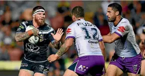  ?? GETTY IMAGES ?? Cowboys forward Josh McGuire takes on the Storm defence.