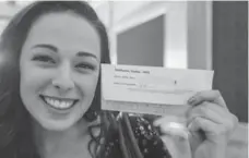  ?? DAVID COOPER PHOTOS/TORONTO STAR ?? Hayley Matheson shows off her ticket before seeing Once. A computer program matched 600 couples, who met for the first time at the show.