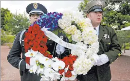  ?? Rachel Aston Las Vegas Review-journal @rookie__rae ?? Officers carry flowers at a ceremony Thursday at Police Memorial Park to honor fallen Southern Nevada law enforcemen­t officers.