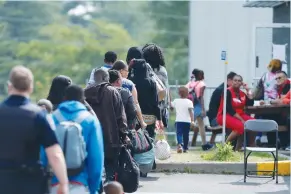  ?? (Christinne Muschi/Reuters) ?? ASYLUM-SEEKERS WAIT to be processed at Canada Border Services in Lacolle, Quebec, on Friday.