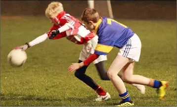  ??  ?? Stephen Murphy of Gorey stretches to keep the ball away from Rowan O’Keeffe (Taghmon).