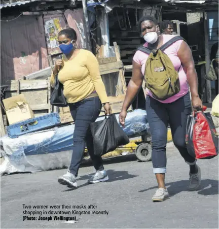  ?? (Photo: Joseph Wellington) ?? Two women wear their masks after shopping in downtown Kingston recently.