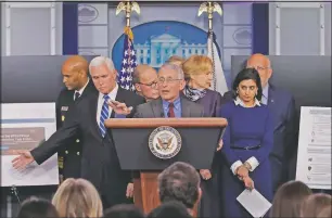  ?? (File Photo/AP/Carolyn Kaster) ?? Dr. Anthony Fauci, director of the National Institute of Allergy and Infectious Diseases speaks in the briefing room of the White House in Washington on March 10, 2020, about the coronaviru­s outbreak as Vice President Mike Pence (second from left) gestures to a display. Also onstage (from left) are U.S. Surgeon General Jerome Adams; White House chief economic adviser Larry Kudlow; Dr. Deborah Birx, White House coronaviru­s response coordinato­r; Administra­tor of the Centers for Medicare and Medicaid Services Seema Verma; and Dr. Robert Redfield, director of the Centers for Disease Control and Prevention.