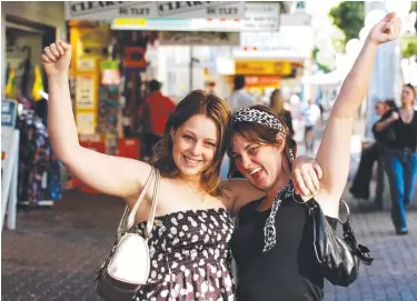  ??  ?? NEW WORSHIP: Tiah Mitchell and Alisha Austin were excited when Sunday trading started in Townsville.