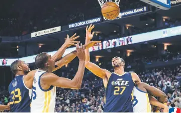  ??  ?? Utah Jazz centre Rudy Gobert (second right) holds back Golden State Warriors forward Draymond Green as he battles for the ball against Golden State Warriors forward Kevin Durant (second left) with Utah Jazz centre Boris Diaw during the third quarter at...