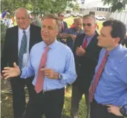  ?? PHOTO BY DAVE FLESSNER ?? Tennessee Gov. Bill Haslam, center, talks about the $27.1 million investment a new textile company is making in Pikeville to create 1,000 jobs. With Haslam, from left, are Pikeville Mayor Philip “Winky” Cagle, Bledsoe County Mayor Gregg Ridley and Troy...