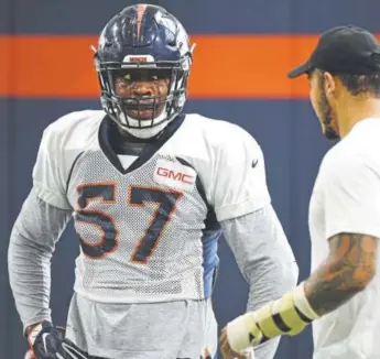  ?? John Leyba, The Denver Post ?? Broncos outside linebacker Shane Ray, right, gives some pointers to rookie outside linebacker Demarcus Walker during drills at preseason practice.