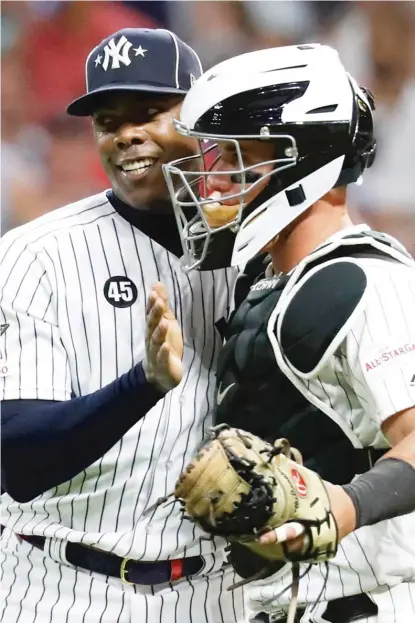  ??  ?? Aroldis Chapman (with White Sox catcher James McCann at the 2019 All-Star Game) is doing well overall despite mild symptoms.