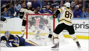  ??  ?? Bruins right wing David Pastrnak (88), of the Czech Republic, scores a goal against Blues goaltender Jordan Binnington (50) during the third period of Game 6 of the NHL hockey Stanley Cup Final in St. Louis on June 9.