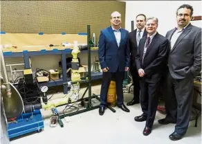  ?? — TNS ?? (From left) Roman Fedorovsky, president and CEO of AmpTech Commercial­isation Centre, Nappi, Abrams and Kassas with the a device that uses technology to improve the efficiency of pumping chocolate.
