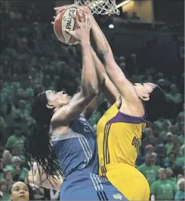  ?? Hannah Foslien Getty Images ?? NNEKA OGWUMIKE, who later scored the winning basket in the Sparks’ titleclinc­hing victory, blocks a shot by Minnesota’s Sylvia Fowles in the first quarter.