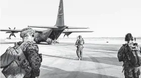  ?? Jim Huylebroek / NYT ?? American military personnel at Camp Shorabak in the Helmand province of Afghanista­n on Sept. 26.