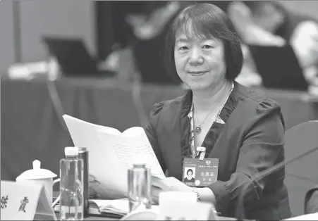  ?? PHOTOS BY ZOU HONG / CHINA DAILY ?? Chen Xia, researcher at the Institute of Philosophy of the Chinese Academy of Social Sciences, during this month’s second session of the 14th National Committee of the Chinese People’s Political Consultati­ve Conference.