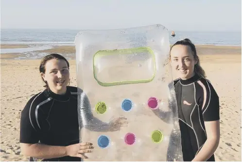  ?? PICTURE: RNLI/SWNS ?? 0 Eilidh and Isla Noble with the lilo that Isla used to carry out the rescue at Waters of Philorth