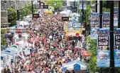  ?? CONTRIBUTE­D ?? People pack Fifth Street at a previous Taste of Cincinnati. This year’s event will feature 77 different food vendors.
