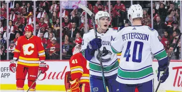  ?? GETTY IMAGES ?? Vancouver’s Bo Horvat celebrates a goal with Elias Pettersson during the Canucks game in Calgary on Saturday night.