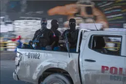  ?? RICARDO ARDUENGO/ AFP VIA GETTY IMAGES ?? Haitian National Police patrols the streets on Oct. 27, 2021. A heavily armed gang attacked Haiti’s largest courthouse on June 10, and continue to control the building. The gang, called “5 segonn,” is one of several that have terrorized the country in recent months.