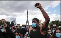  ?? FRANCOIS MORI / AP FILE ?? In this June 6 file photo, hundreds of demonstrat­ors gather on the Champs de Mars as the Eiffel Tower is seen in the background during a demonstrat­ion in Paris to protest against the recent killing of George Floyd.