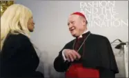  ?? DOMENICO STINELLIS — THE ASSOCIATED PRESS ?? Cardinal Gianfranco Ravasi, right, talks to designer Donatella Versace at Palazzo Colonna in Rome, Monday.