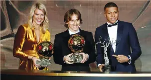  ?? (Reuters) ?? REAL MADRID’S Luka Modric (center), Olympique Lyonnais’s Ada Hegerberg (left) and Paris Saint Germain’s Kylian Mbappe pose with their respective awards at Monday night’s Ballon d’Or ceremony in Paris.