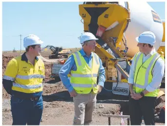  ?? ?? ON TRACK: Wellcamp quarantine hub civil constructi­on manager George Jackson, Wagner Corporatio­n director Joe Wagner and Queensland Deputy Premier Steven Miles.