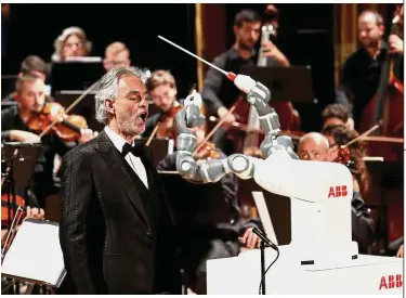  ?? — Reuters ?? High-tech: Humanoid robot YuMi conducts the Lucca Philharmon­ic Orchestra at the Verdi Theatre in Pisa, Italy. ABB says its YuMi robots will be deployed on many of the small parts assembly tasks needed to manufactur­e its robot.