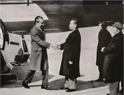  ?? ?? A file photo shows Chinese Premier Zhou Enlai and US President Richard Nixon shake hands at an airport in Beijing on February 21, 1972.