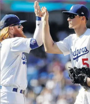  ?? AP PHOTO ?? Los Angeles Dodgers third baseman Justin Turner, left, celebrates with shortstop Corey Seager after the Dodgers defeated the San Diego Padres 6-4 in a baseball game in Los Angeles on Sunday.