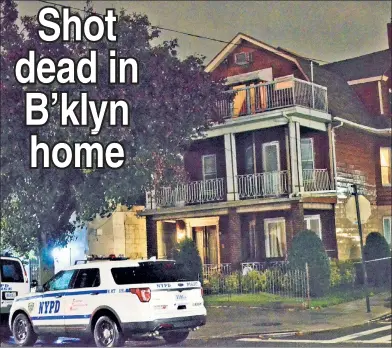  ??  ?? HOUSE OF HORROR: Police guard the Sheepshead Bay building where a 77-year-old man with suspected ties to organized crime was found shot twice in the back of the head by his grandson Friday afternoon.