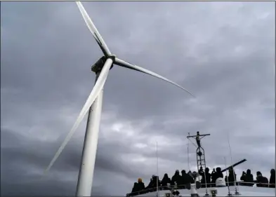  ?? (File Photo/AP/David Goldman) ?? Guests tour one of the turbines of America’s first offshore wind farm, owned by the Danish company, Orsted, off the coast of Block Island, R.I., as part of a wind power conference, in October.