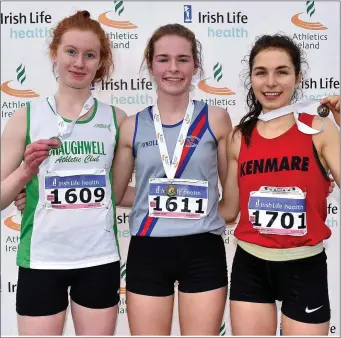  ??  ?? Shauna Doellken-O’Shea (right) of Kenmare AC, who won a silver medal in the Girls under-19 4,000m event at the AAI Novice & Juvenile Uneven Age Cross-Country Championsh­ips at the WIT Arena in Waterford, pictured with gold medallist Niamh Carey, centre,...