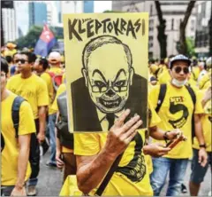  ?? TED ALJIBE/AFP ?? A protester holds a placard with a caricature depicting Malaysian Prime Minister Najib Razak during a mass rally organised by Bersih calling for the resignatio­n of Najib in Kuala Lumpur on Saturday.