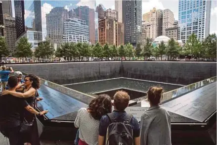  ?? AFP PIX ?? Visitors at the National Sept 11 Memorial and Museum in New York City.