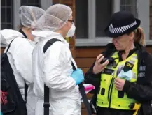  ??  ?? Search: A team of forensic officers yesterday