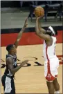  ?? MICHAEL WYKE ?? Houston Rockets guard James Harden, right, puts up a shot over San Antonio Spurs guard Lonnie Walker IV, left, during the first half of an NBA basketball game Tuesday, Dec. 15, 2020, in Houston.