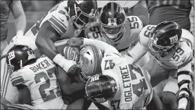  ?? PAUL SANCYA/AP PHOTO ?? Detroit Lions running back Tra Carson (34) is stopped by the New York Giants defense during Sunday’s game at Detroit.