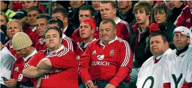  ?? PHOTOS: LAWRENCE SMITH/FAIRFAX NZ ?? Lions fans weren’t left with much to smile about after being repelled 48-18 by the All Blacks in the second test in Wellington in 2005.