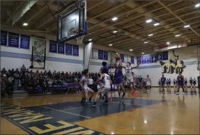  ?? Photo by Megan Gannon ?? MVP — The Nanooks’ Jade Green, No. 13, blocks a shot in a game against the Kotzebue Huskies. He was named MVP of the Subway Showdown Tournament held in Nome last weekend.