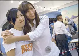  ?? REUTERS ?? Kwong Po- yin ( left), a member of ‘ Umbrella Soldier’ group Youngspira­tion, is hugged by her election partner Yau Waiching after Kwong won a district council election in Hong Kong yesterday.