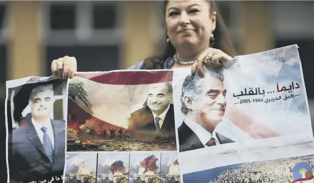  ?? PICTURE: PIERRE CROM/GETTY IMAGES ?? A supporter of assassinat­ed former Lebanese premier Rafiq Hariri holds posters outside the Lebanon Tribunal in The Hague yesterday