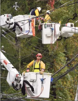  ?? H John Voorhees III / Hearst Connecticu­t Media ?? Crews work on downed power lines on South Street in Bethel on Wednesday. A violent storm that moved through the area overnight knocked out power.