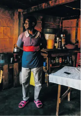 ??  ?? ZACARIAS CHIRINZE STANDS IN THE LIVING ROOM OF HIS HOME IN OOGIES, MPUMALANGA