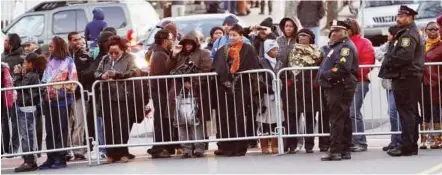  ??  ?? One moment in time: Fans standing outside the Whigham Funeral Home where people attended Houston’s wake before the funeral yesterday. — Reuters